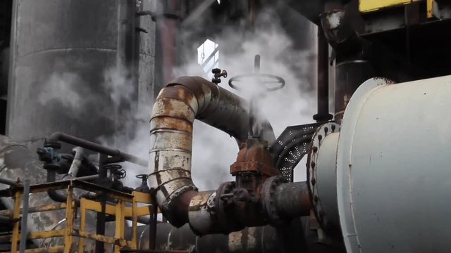 Steam leaks, rust and dirt on industrial manufacturing plant.