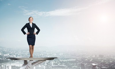 Confident elegant businesswoman presented on metal tray against cityscape background