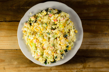 Salad with crab sticks, corn, cucumber, and eggs