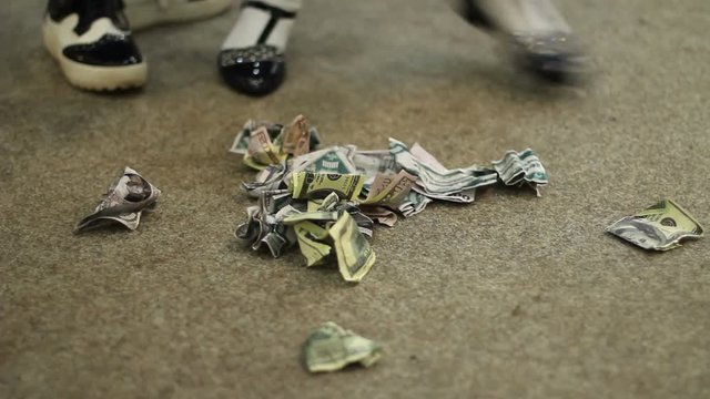 Many 100 US crumpled dollars bank notes on the floor