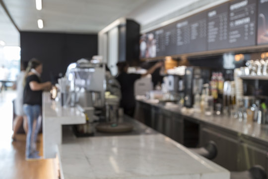 Blurred picture of counter cashier in modern coffee shop .