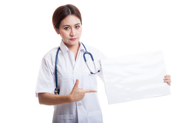 Young Asian female doctor point to a blank sign.