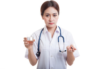 Young Asian female doctor with water and medicine.