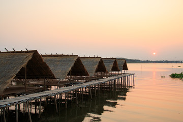 Fototapeta na wymiar Huts over water with sunset