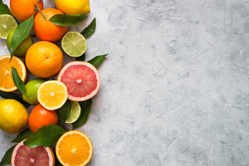 Citrus fruit on grey concrete table. Food background. Healthy eating