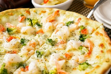 shrimp pizza on table