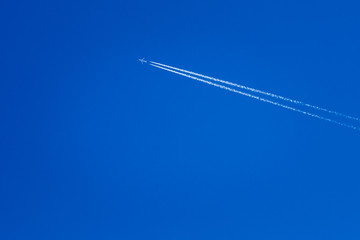 Airplane In The Sky With Plane Trails