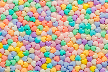 Fototapeta na wymiar Colorful pastel of heart shaped beads on white background, use a