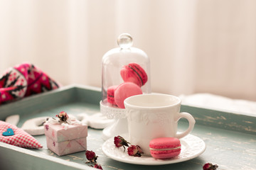 romantic breakfast in bed. Cappuccino ,strawberry macaroons ,gift box on wooden blue table. Valentine's day concept