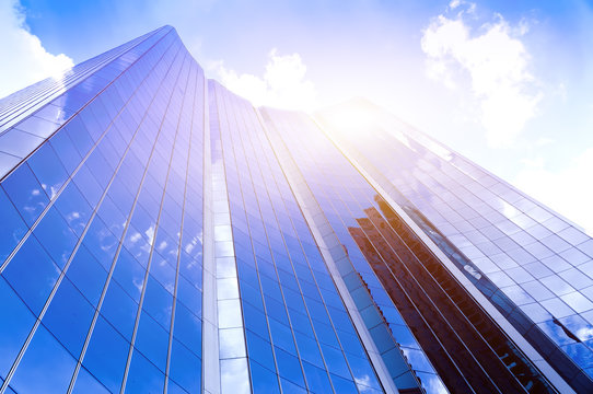 Modern glass silhouettes of skyscrapers in the city and dramatic sunlight © mrfiza