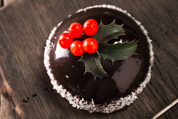 French mousse cake covered with chocolate mirror glaze. Modern european cake pastry with christmas decor
