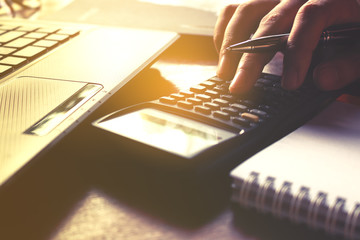 Closeup of hand female using calculator and calculate about cost