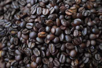 Arabica coffee beans on a black wooden table