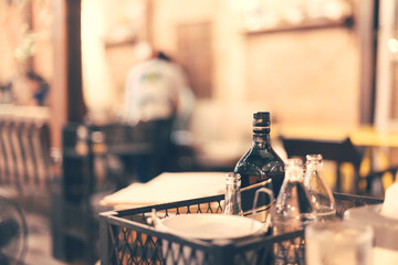 Alcohol, soda, water and ice place on table in restaurant in soft focus and warm fall color.
