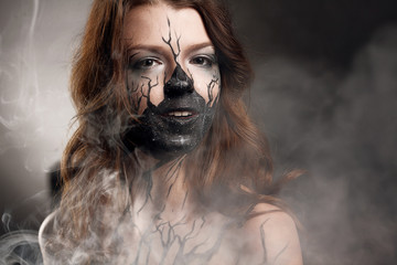 girl with make up and electronic cigarette making clouds