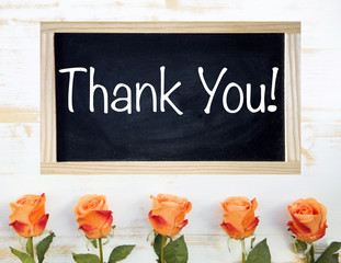 orange roses and black chalkboard with words Thank You