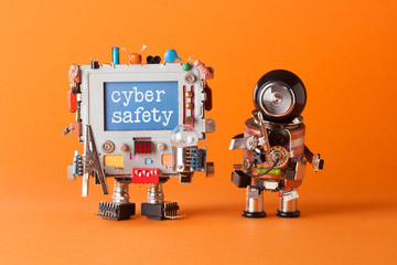 Cyber safety concept. System administrator robot and creative computer character with text message on blue desktop. Orange paper background