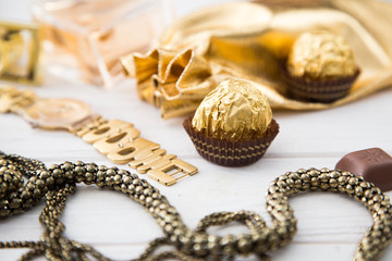 Women's set of accessories and sweets in golden color 