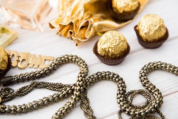 Women's set of accessories and sweets in golden color 