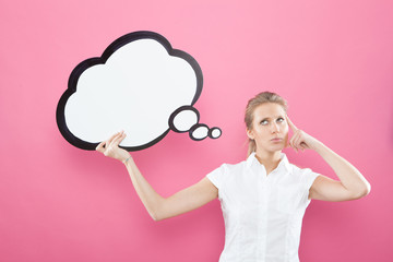 pretty young blond caucasian woman thinking ideas with comic baloon  on pink background