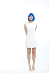 pretty young brunette caucasian smiling woman with blue wig on white background