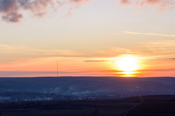 Landscape of Negresti village at red sunset in Moldova, golden autumn, road and fileds of vines, antenna