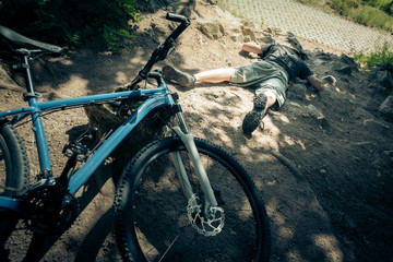 Fototapeta na wymiar Young Mountain Biker Fallen Off His Bike