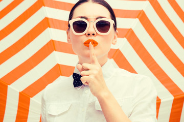 Stylish beautiful woman wearing white chemise and sunglasses