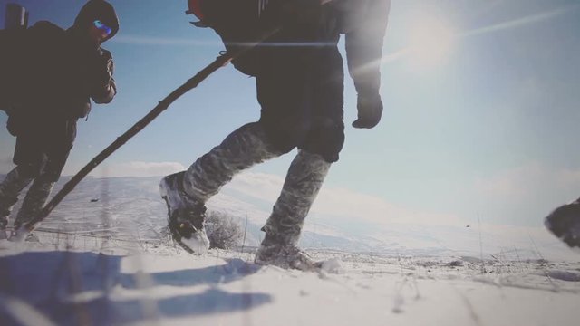 Close-up of hikers Legs wandering in the snow in the mountains. Vignette color correction