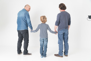Back turned gay male couple with son
