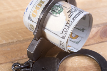 Handcuffs and dollar bills