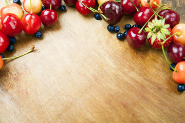Many fresh fruits lie on a wooden board