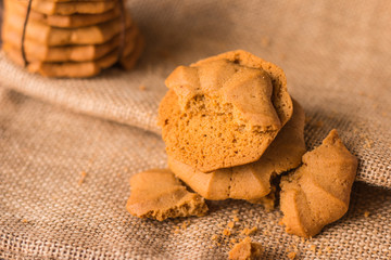 Chocolate chip cookies and a glass of milk on a on the hessian n
