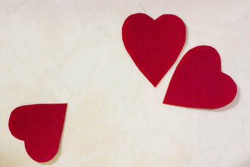 A three decorative red hearts on light background