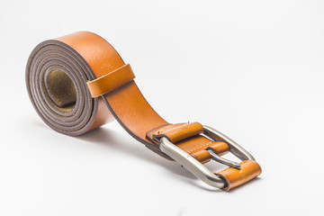 Brown leather belt on white background.