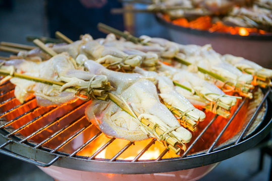 Grilled chicken skewers on stove