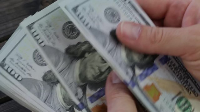 Counting american paper money close-up. Man hands counting a lot of one hundred dollar bills