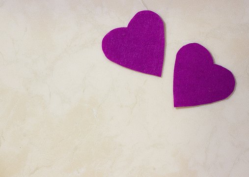 A two decorative purple hearts on light background