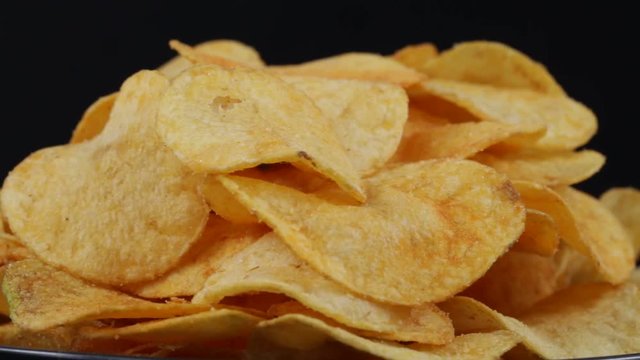 Rotating potato chips close up, macro view food background