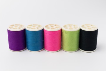 Colorful reel , colorful thread on white background