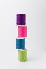 Colorful reel , colorful thread on white background