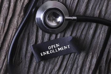 Medical Concept- OPEN ENROLLMENT word written on label tag with