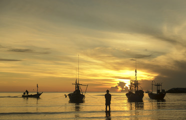 morning sea life with boat and fisherman, in sunrise