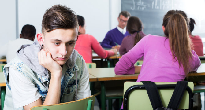 Alone outcasted student being mobbed by other students