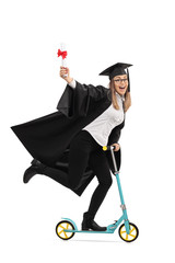 Naklejka premium Overjoyed graduate student holding a diploma and riding a scoote