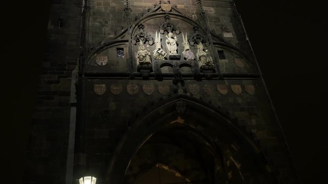 Gothic archtecture of Charles bridge over Vltava river in Czech Republic capital slow tilt 3840X2160 UHD tilting footage - Czechia capital Prague Lesser Town tower by night 2160p UltraHD 
