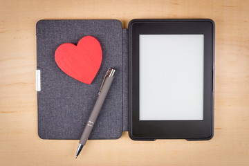 E-book reader with red heart and copy space