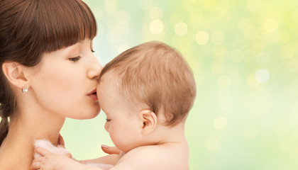 happy mother kissing adorable baby