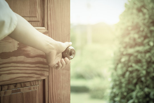 Women hand open door knob or opening the door.