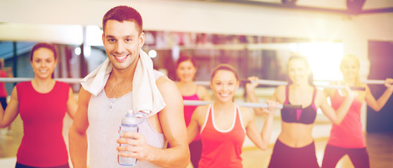 smiling trainer in front of group of people